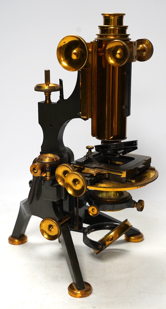 A late 19th/early 20th century brass microscope, by Watson and Sons, in a fitted case with some alternative lenses and other accessories, case 39.5cm high. Condition - fair